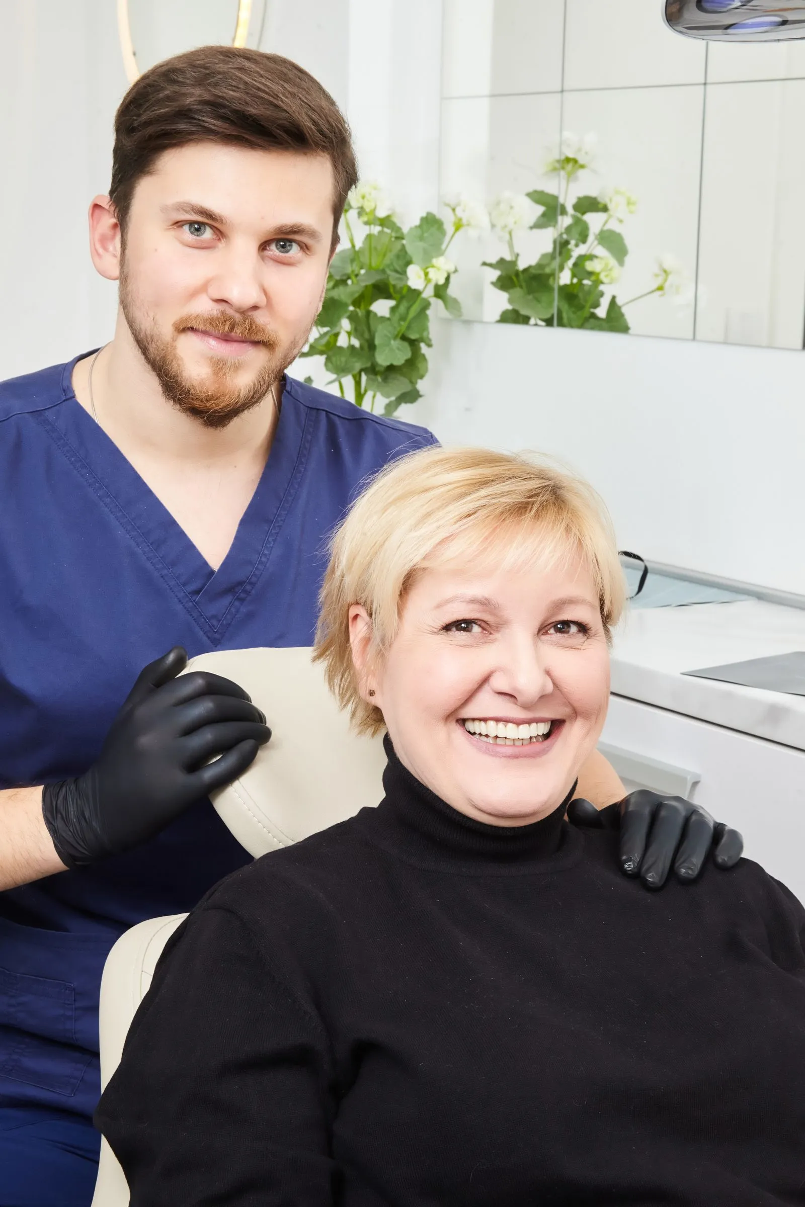 Dentist with a smiling patient in a bright, calm room